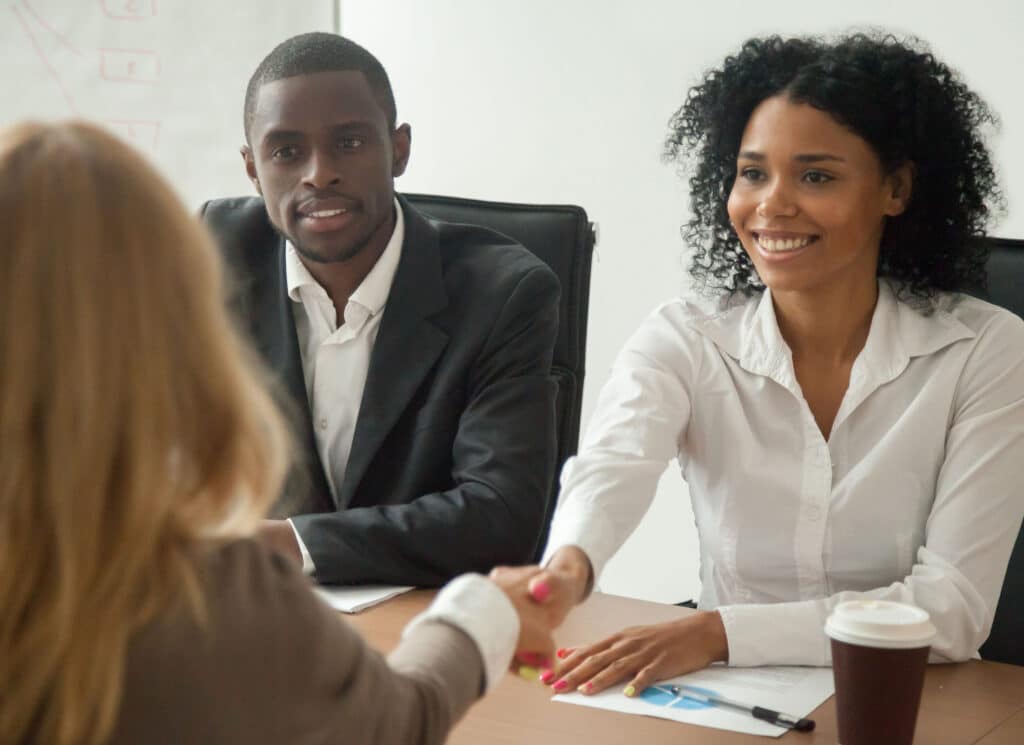 Welcoming female applicant at job interview for staffing solutions